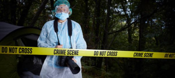 Forensics researcher photographing a blood  at a murder scene